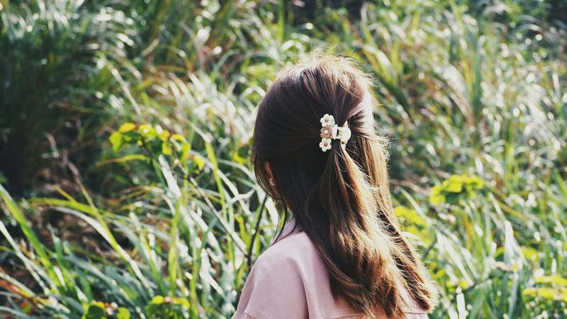 Elegant hair barrettes arranged on a soft beige linen backdrop with natural lighting