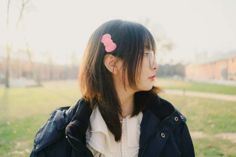 Founder styling hair with a pearl barrette in natural light
